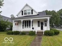 Charming home features a cozy front porch and well-maintained landscaping at 201 N 11Th St, Elwood, IN 46036