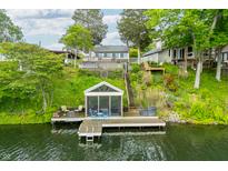 Lake house with dock and screened-in porch offering serene waterfront living at 242 W Warford Dr, , IN 46164
