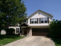 Charming two-story home with a well-manicured lawn and inviting front entrance, perfect for Gathering living at 2628 Newaygo Dr, Indianapolis, IN 46217