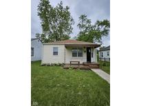 Charming bungalow featuring a well-maintained lawn, landscaped flower bed, and cozy front porch at 3305 E 30Th St, Indianapolis, IN 46218