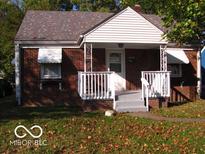 Charming one-story brick home with a covered front porch and tidy landscaping at 4830 Wentworth Blvd, Indianapolis, IN 46201