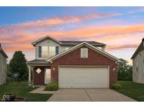 Charming two-story home with a brick facade, inviting entrance, and attached two-car garage at 513 Sun Catcher Dr, Avon, IN 46123