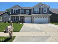 Beautiful two-story home featuring a manicured lawn, stone accents, and a two-car garage at 5420 Orwell Ct, Indianapolis, IN 46239