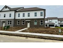 New two-story townhouse with brick and white siding and a walkway leading to the front door at 6248 Cascades Dr, Whitestown, IN 46075