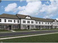 Charming townhome featuring a neutral brick and white siding exterior with black shutters and modern design elements at 6248 Cascades Dr, Whitestown, IN 46075