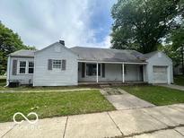 Classic single-story home with covered porch, lawn, and attached one-car garage at 7607 E 46Th St, Indianapolis, IN 46226