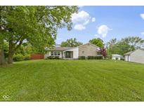 Well maintained, charming ranch home on a large lot with mature trees, lush lawn, and stone accents at 823 W 200 N, Greenfield, IN 46140
