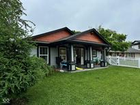 Charming home featuring a cozy front porch and well-maintained lawn at 9527 Pepperidge Dr, Indianapolis, IN 46235