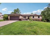 Charming single-story home with a manicured lawn, attached garage, and lovely landscaping at 976 Santa Maria Dr, Greenwood, IN 46143
