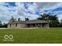 Charming single-story brick home with a lush green lawn and ample space at 11898 N 200 W, Fountaintown, IN 46130