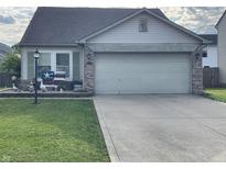 Charming single-Gathering home with a two-car garage and well-maintained lawn at 1420 Wigwam Ln, Martinsville, IN 46151