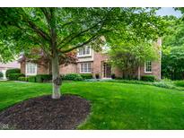 Well-manicured front yard with lush green lawn, mature trees, and a classic brick home at 14274 Matt St, Carmel, IN 46033