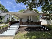 Charming house featuring a cozy front porch and a well-manicured landscaped yard at 1440 Sycamore St, Columbus, IN 47201
