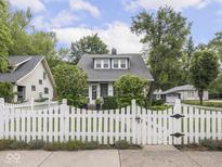 Charming home featuring a white picket fence, well-manicured lawn, and inviting curb appeal at 150 E 46Th St, Indianapolis, IN 46205
