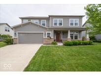 Charming two-story home with a well-maintained lawn and a two car attached garage at 15675 Myland Dr, Noblesville, IN 46062