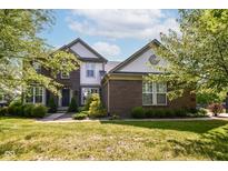Beautiful two-story home featuring manicured landscaping, a brick facade and light-colored siding accents at 18967 Mill Grove Dr, Noblesville, IN 46062