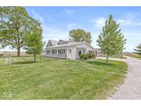 Charming home featuring a sunroom, well-maintained lawn, and mature trees at 20530 Victory Chapel Rd, Noblesville, IN 46060