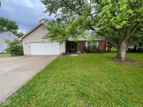 Charming home featuring a well-manicured lawn, brick accents, an attached garage, and mature trees at 356 Seabreeze Cir, Avon, IN 46123