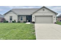 Charming single-story home featuring a two-car garage, manicured lawn and stone facade at 4920 E Daisy Ln, Mooresville, IN 46158