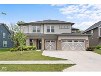 Beautiful two-story home with a three-car garage and a well-manicured lawn at 5264 Veranda Dr, Noblesville, IN 46062