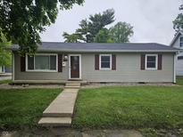 Charming single-story home featuring gray siding, red shutters, and a well-maintained front lawn at 720 Henry St, Lebanon, IN 46052