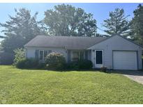 Charming single-story home with a well-maintained lawn, attached garage, and mature landscaping at 9533 Burrwood Ct, Indianapolis, IN 46235
