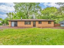 Brick home featuring a well-maintained lawn and mature trees, providing a serene and private setting at 10346 Wilson Rd, Brownsburg, IN 46112