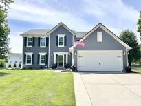 Charming two-story home featuring a two-car garage, a well-manicured lawn, and a welcoming front entrance at 10847 Woodlook Ln, Indianapolis, IN 46239