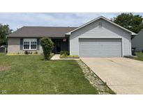 Charming single-story home with gray siding, brick accents, and a well-manicured lawn at 1562 Prairieview Ln, Greenfield, IN 46140