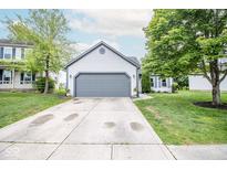 Charming one-story home with a two-car garage, a well-manicured lawn, and mature shade trees at 17841 Grassy Knoll Dr, Westfield, IN 46074
