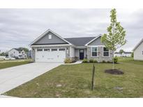 Charming single-Gathering home showcasing a well-manicured lawn, two car garage, and stone accents at 1863 River Birch Dr, Greenfield, IN 46140