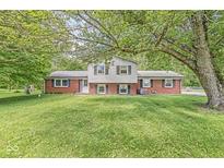 Charming brick home featuring a well-maintained lawn, mature trees, and classic architectural details at 2346 N State Road 39, Danville, IN 46122