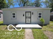 Charming single-story home featuring a secure front door and well-maintained landscaping at 2421 N Arsenal Ave, Indianapolis, IN 46218