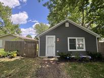Charming bungalow with gray siding, white trim, landscaped flower bed, and a well-manicured lawn at 3041 S Rybolt Ave, Indianapolis, IN 46241