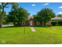 Charming brick home with mature trees and well-maintained lawn on a bright sunny day at 3602 N Colorado Ave, Indianapolis, IN 46218
