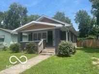 Charming one-story home featuring a cozy front porch and a well-maintained lawn at 4325 Norwaldo Ave, Indianapolis, IN 46205