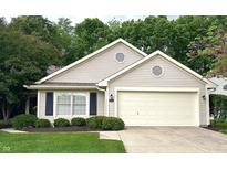 Charming single-story home with manicured lawn, attached two-car garage, and beautiful landscaping at 6366 Stratford N Dr, Fishers, IN 46038