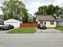Charming single-Gathering home with a detached garage and a well-maintained front lawn at 710 Bacon St, Indianapolis, IN 46227
