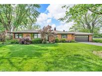 Charming single-story brick home with a lush green lawn and mature trees at 7380 N State Road 267, Brownsburg, IN 46112