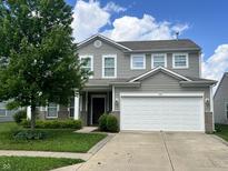 Two-story home featuring a two-car garage and well-maintained landscaping and gray siding at 842 Westpointe Dr, Shelbyville, IN 46176