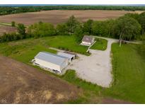 Expansive property featuring a charming home, large outbuilding, and sprawling fields at 8468 S County Road 575 E, Mooresville, IN 46158