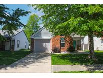 Charming single Gathering home with brick facade, attached garage, and well-maintained front yard at 9774 Foxboro Ln, Fishers, IN 46038