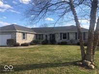 Charming one-story brick home with a well-maintained lawn and inviting curb appeal at 1045 Springway Dr, Shelbyville, IN 46176