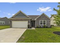 Charming one-story brick home with a well-manicured lawn, attached garage, and welcoming front entrance at 11815 Adair Pl, Indianapolis, IN 46229