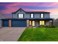 Charming two-story home with a brick and siding exterior, well-manicured lawn, and an attached two-car garage at 1199 Oak Leaf Rd, Franklin, IN 46131
