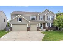 Charming two-story home with a three-car garage and well-manicured lawn at 19534 Forsythe Dr, Noblesville, IN 46060