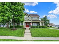 Charming two-story home with a manicured lawn and inviting red front door at 241 N Liberty Blvd, Mooresville, IN 46158