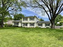 Charming two-story home with lush green lawn and classic curb appeal and dark shutters at 377 4Th E Ct, Carmel, IN 46033