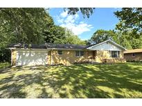 Charming brick ranch-style home with a well-manicured lawn and an attached one-car garage at 403 Us Highway 31 N, Greenwood, IN 46142