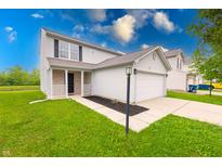 Charming two-story home with a well-manicured lawn and attached two-car garage at 4056 Orchard Valley Ln, Indianapolis, IN 46235